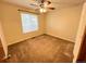 A cozy bedroom featuring a window with natural light and carpeted flooring at 2043 S Salida St, Aurora, CO 80013