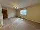 Large bedroom features a window with natural light, ceiling fan, carpet, and plenty of open space at 2043 S Salida St, Aurora, CO 80013