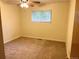 Bedroom featuring a window with natural light, ceiling fan, and carpeted flooring at 2043 S Salida St, Aurora, CO 80013