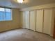 Bedroom featuring large closet, neutral walls, carpet flooring, and window at 2043 S Salida St, Aurora, CO 80013