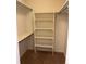 Well-organized walk-in closet features shelving and hanging rods, maximizing storage space and efficiency at 2043 S Salida St, Aurora, CO 80013