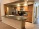 Well-equipped kitchen with stainless steel appliances, light wood cabinets, and a peninsula at 2043 S Salida St, Aurora, CO 80013