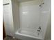 Bathroom shower and tub with clean white tile and a sliding door, providing a pristine space at 2043 S Salida St, Aurora, CO 80013