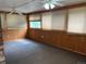 Bright sunroom with wood paneling, carpet flooring and multiple windows at 2043 S Salida St, Aurora, CO 80013
