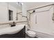 Cozy bathroom featuring a vanity with drawers, a shower-tub combo, and modern fixtures at 735 S Clinton St # 5B, Denver, CO 80247