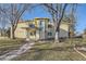 Inviting exterior view of a home with mature trees and a well-manicured lawn on a sunny day at 735 S Clinton St # 5B, Denver, CO 80247