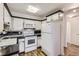 Efficient kitchen featuring black countertops, white cabinets, and modern appliances at 735 S Clinton St # 5B, Denver, CO 80247