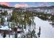 Stunning mountain home nestled among pine trees with snow covered mountain backdrop at 127 Marks Ln, Breckenridge, CO 80424