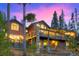 Multi-level deck with stone columns and wooded backdrop at dusk at 127 Marks Ln, Breckenridge, CO 80424