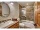 Cozy bathroom with a shower-tub combo, earth-toned tiles, and a wooden vanity at 127 Marks Ln, Breckenridge, CO 80424