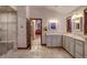 Bright bathroom with tiled flooring, a glass-enclosed shower, and a double sink vanity at 127 Marks Ln, Breckenridge, CO 80424