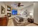 Cozy bedroom featuring a fireplace, ceiling fan, a comfortable bed, and soft lighting at 127 Marks Ln, Breckenridge, CO 80424