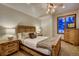 Well-lit bedroom featuring a ceiling fan, a comfortable bed, and wooden furniture at 127 Marks Ln, Breckenridge, CO 80424