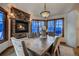 Cozy dining room boasts a stone fireplace and large windows offering serene views of the outdoors at 127 Marks Ln, Breckenridge, CO 80424