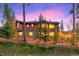 Exterior showcasing a home with large windows and stone accents, set against a twilight sky at 127 Marks Ln, Breckenridge, CO 80424