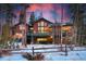 Inviting exterior view showcasing a multi-story home with a wooden deck, stone accents, and beautiful sunset backdrop at 127 Marks Ln, Breckenridge, CO 80424