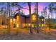 Elegant mountain home featuring large windows and stone accents under a twilight sky at 127 Marks Ln, Breckenridge, CO 80424