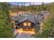 Expansive mountain home featuring warm exterior lighting and a three car garage at 127 Marks Ln, Breckenridge, CO 80424