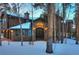 Charming stone and wood home entrance featuring an arched entryway and winter landscape at 127 Marks Ln, Breckenridge, CO 80424