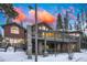 Exterior showcasing a home with a multi-level deck, stone facade, and a scenic winter landscape at 127 Marks Ln, Breckenridge, CO 80424