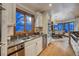 Bright kitchen with granite countertops, stainless steel appliances, and a view into the dining area at 127 Marks Ln, Breckenridge, CO 80424