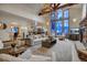 Open-concept living room boasts a stone fireplace, vaulted ceilings, and large windows for natural light at 127 Marks Ln, Breckenridge, CO 80424