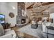 Spacious living room with a grand stone fireplace, comfortable seating, and a view of the staircase at 127 Marks Ln, Breckenridge, CO 80424