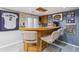 Basement bar featuring wooden bar, stools, and sports memorabilia for a cozy entertainment space at 9431 Crossland Way, Highlands Ranch, CO 80130