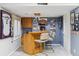 Basement bar featuring bar stools, wood counter, and decorative walls at 9431 Crossland Way, Highlands Ranch, CO 80130