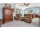 Open bedroom with vaulted ceiling, wood armoire and sitting area at 9431 Crossland Way, Highlands Ranch, CO 80130
