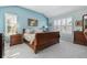 Bedroom with blue walls, plantation shutters and wood furniture at 9431 Crossland Way, Highlands Ranch, CO 80130
