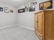 Neutral bedroom with gray carpet and a wooden armoire; gallery wall with various framed pictures at 9431 Crossland Way, Highlands Ranch, CO 80130
