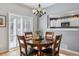 Dining room with natural light, hardwood floor, and pass-through to the kitchen at 9431 Crossland Way, Highlands Ranch, CO 80130