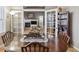 Dining room with French doors leading into living room with stone fireplace and built-ins at 9431 Crossland Way, Highlands Ranch, CO 80130
