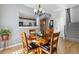 Dining area shows hardwood floors and pass-through to the kitchen and stairs to upper level at 9431 Crossland Way, Highlands Ranch, CO 80130