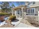 Charming home with stone pillar accents, covered entrance, bench, and landscaped front yard at 9431 Crossland Way, Highlands Ranch, CO 80130