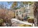 Inviting front entrance with a covered porch, stone accents, and well-manicured landscaping, creating a warm welcome at 9431 Crossland Way, Highlands Ranch, CO 80130