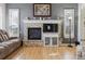 Living room featuring a stone fireplace with a large TV and hardwood flooring at 9431 Crossland Way, Highlands Ranch, CO 80130