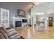 Comfortable living room with a stone fireplace, large windows, and open dining area at 9431 Crossland Way, Highlands Ranch, CO 80130