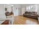 Bright living room features hardwood floors, white shutters, and a comfortable, oversized reclining sofa at 9431 Crossland Way, Highlands Ranch, CO 80130