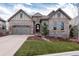 Charming stone-and-siding home with a well-manicured lawn and an attached two-car garage at 634 Hiddenbrook Ct, Highlands Ranch, CO 80126