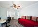 Inviting bedroom showcasing a ceiling fan, a window with stylish panes, and a comfortable red daybed at 20304 Vista Cir, Parker, CO 80138