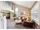 Spacious living room with vaulted ceilings, large windows, and comfortable leather seating at 20304 Vista Cir, Parker, CO 80138