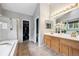 Bright main bathroom featuring double sinks, a separate shower, and a large soaking tub, blending style and function at 20304 Vista Cir, Parker, CO 80138