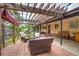 Cozy backyard patio with a pergola, seating, and views of lush landscaping at 9650 W 35Th Ave, Wheat Ridge, CO 80033