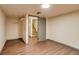 Finished basement area with durable vinyl floors and access to a staircase at 9650 W 35Th Ave, Wheat Ridge, CO 80033