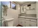 Cozy bathroom featuring a white single sink vanity, mirror, and charming decor at 9650 W 35Th Ave, Wheat Ridge, CO 80033