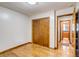Simple bedroom features hardwood floors, closet and doorway leading to an adjoining room at 9650 W 35Th Ave, Wheat Ridge, CO 80033
