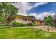 Attractive yellow brick home with a manicured lawn and tasteful landscaping creating a inviting curb appeal at 9650 W 35Th Ave, Wheat Ridge, CO 80033