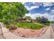 Beautifully landscaped front yard featuring a lush lawn, decorative rocks and healthy green trees at 9650 W 35Th Ave, Wheat Ridge, CO 80033